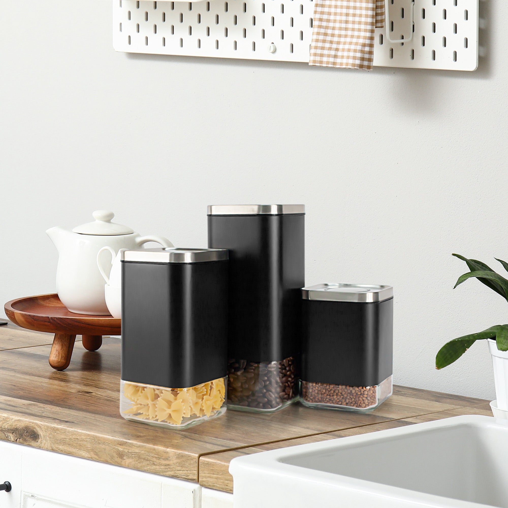 Clear 16oz square glass storage container with a lid from Kaffe Products, showcasing its sleek design and transparent material.