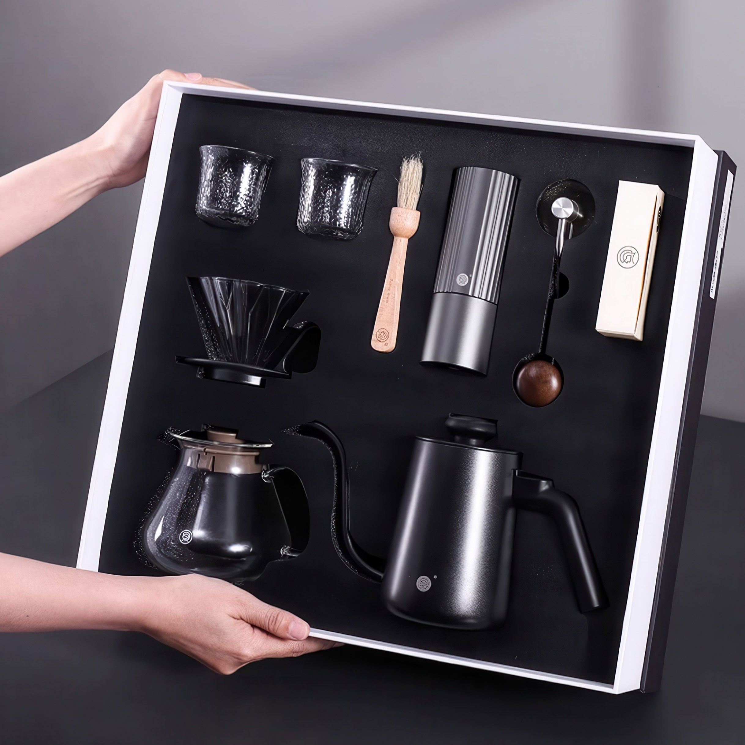 Lastaforest all-in-one pour over coffee kit with black coffee tools, including a dripper, server, and filters for brewing.